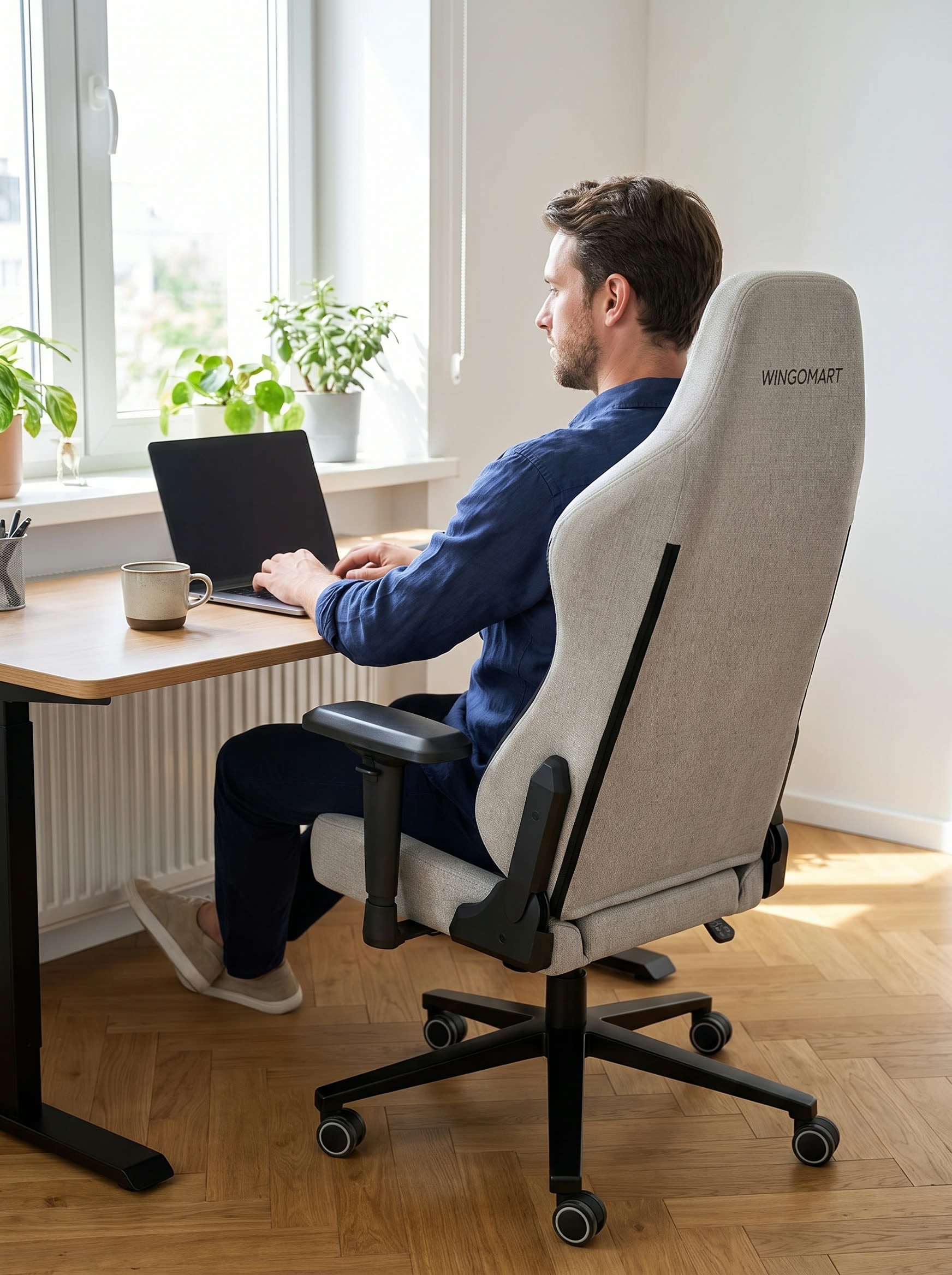 Working at a desk in a WINGOMART RGB PRO chair in daylight